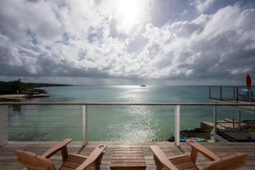 a view of the ocean from the balcony of a resort at Touch of Class Cottage home in Savannah Sound