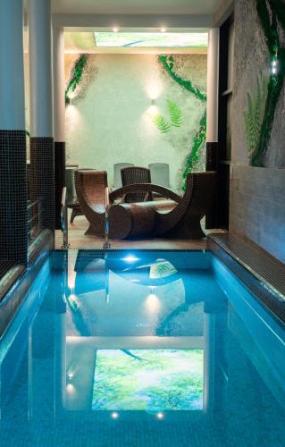 a pool in the middle of a room with a patio at Malina Apartamenty in Szklarska Poręba