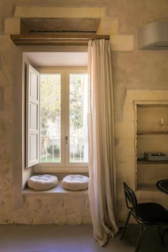 a window with two pillows on a window sill at Palazzo Sant'Anna Lecce in Lecce