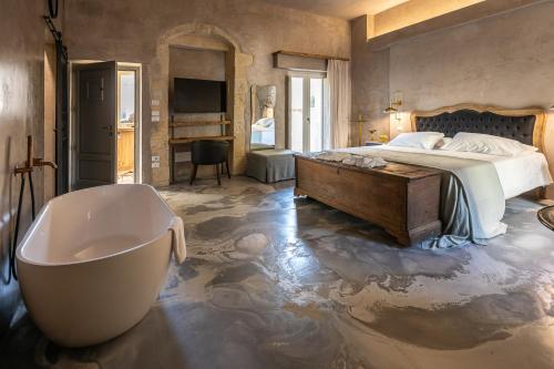 a bedroom with a bath tub and a bed and a bath tub at Palazzo Sant'Anna Lecce in Lecce