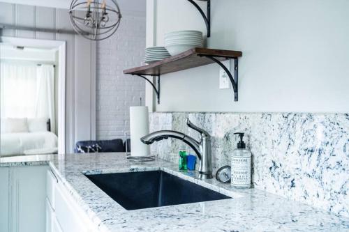 a kitchen with a sink and a counter top at Bungalow in the Heart of Heathwood in Columbia