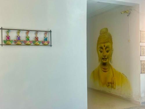 a statue of a woman in a wall at La Curcuma Luxury Homestay in Khajurāho