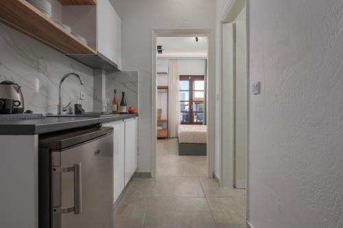 a kitchen with a sink and a counter top at Eleon Suites & Apartments in Afitos