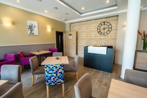 a waiting room with tables and purple chairs at Malina Apartamenty in Szklarska Poręba