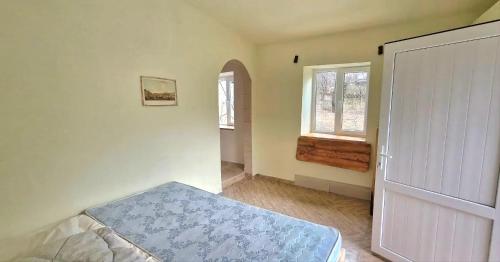 a bedroom with a bed and a window and a door at "Budur" Guest House in Agdan