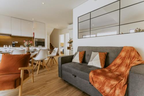 a living room with a couch and a dining room at Bruval Premium Apartments - Gaia in Vila Nova de Gaia