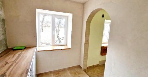 an empty room with a window and a wooden floor at "Budur" Guest House in Agdan