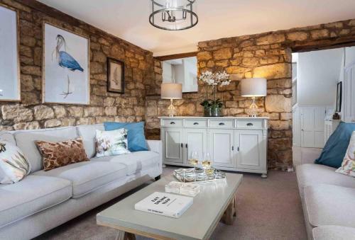 a living room with a couch and a table at Beautiful Cotswold Cottage in Rodborough Stroud in Stroud