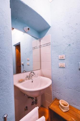 a bathroom with a sink and a mirror at Agriturismo La Costa - Casa Vacanze in Perego