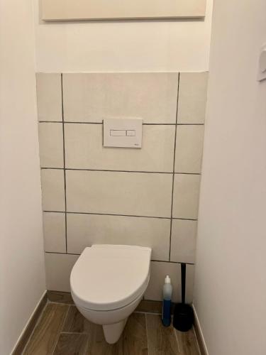 a bathroom with a white toilet in a room at Maisonnette de village à Rasteau in Rasteau