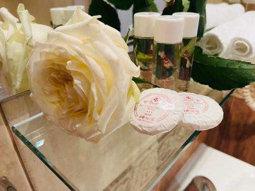 a glass table with a flower and two candles at Slavyanska Beseda Hotel in Sofia