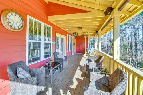 a porch with chairs and a clock on a house at Lakefront Jacksons Gap Retreat with Grill and Dock! in Jacksons Gap