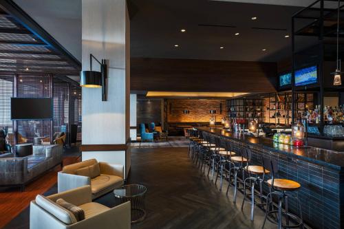 a bar in a hotel with chairs and tables at Baltimore Marriott Waterfront in Baltimore
