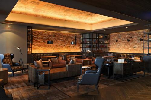a lobby with a bar with couches and chairs at Baltimore Marriott Waterfront in Baltimore