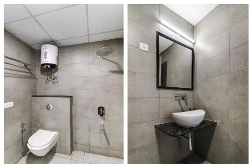 a bathroom with a toilet and a sink and a mirror at RJK Stay - Sohna Road in Gurgaon