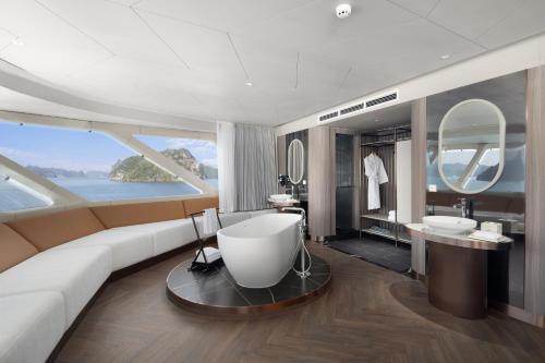 a living room with a couch and a bathroom at Grand Pioneers Halong Bay Cruise 1 in Ha Long
