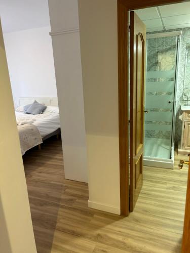 a bedroom with a bed and a glass door at Frente al puerto y junto a la playa del Arenal in Burriana