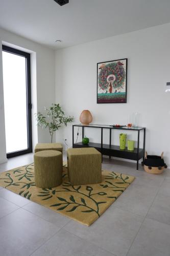 a living room with two chairs and a table at Faro Greenpark APP 01, Cadzand-Bad in Cadzand