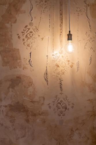 a chandelier hanging from a wall in a room at Palazzo Sant'Anna Lecce in Lecce