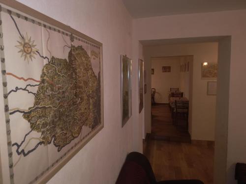 a hallway with paintings on the wall of a room at Poiana Sașilor - Valea Doftanei in Trăisteni
