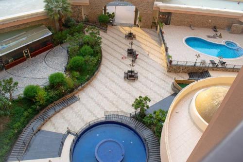 an overhead view of a swimming pool in a mall at Your Silicon Oasis Escape-1BHK in Dubai