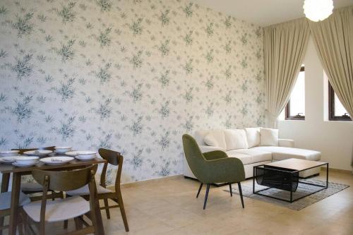 a living room with a couch and a table at Your Silicon Oasis Escape-1BHK in Dubai