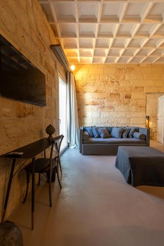 a living room with a couch and a table at Palazzo Sant'Anna Lecce in Lecce