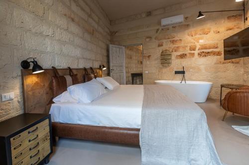 a bedroom with a bed and a bath tub and a sink at Palazzo Sant'Anna Lecce in Lecce