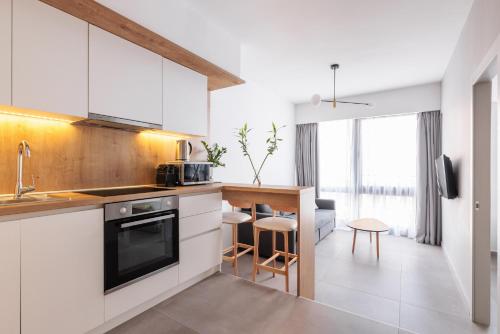 a kitchen with white cabinets and a counter at SKG Cityscape Metropolis in Thessaloniki