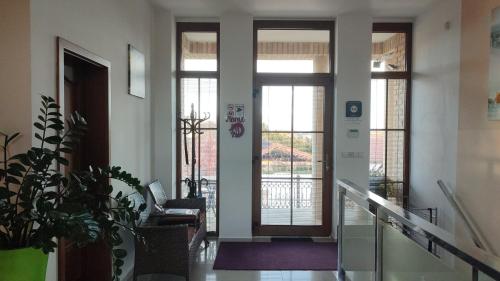 a hallway with a door and a chair in a building at Villa Homestay Nad Helmrovkou in Prague