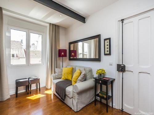 a living room with a couch and a window at Calado Apartments in Lisbon