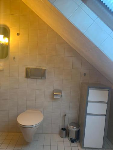 a bathroom with a toilet and a staircase at Ferienwohnung in Oberems