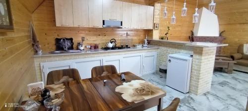 a kitchen with a table and a counter top at Qusar-A-frame in Qusar