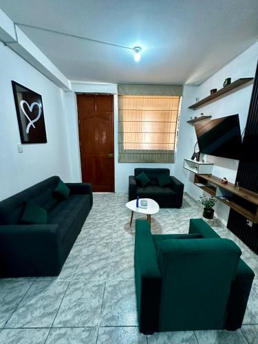 a living room with two couches and a table at Morada Apart in Tacna