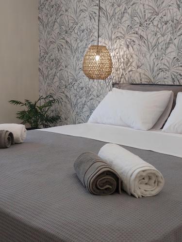 a bedroom with a bed with two towels on it at Nastazia Studios in Laganas