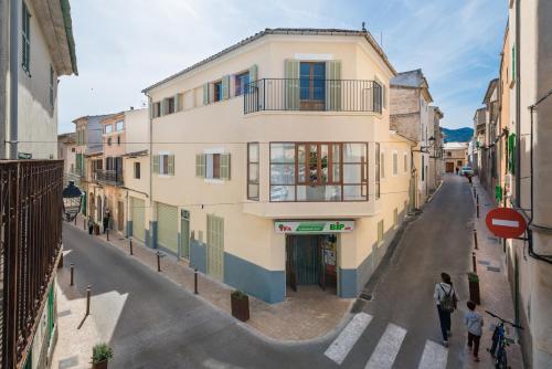 a building on a street with people standing in front of it at Maca Sol in Campanet