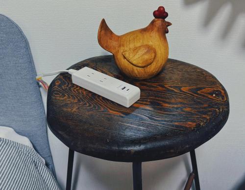 a table with a remote control sitting on top of a stool at 枕木 New house with Huge View for Family-Group in Tokyo