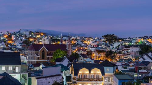 a city lit up at night with buildings at Kim Little House Hotel in Da Lat