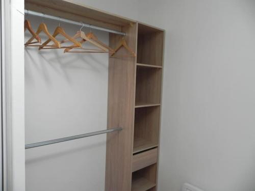 a closet with wooden hangers in a room at VILLA DEL RE 7 dans Résidence avec piscine in La Flotte
