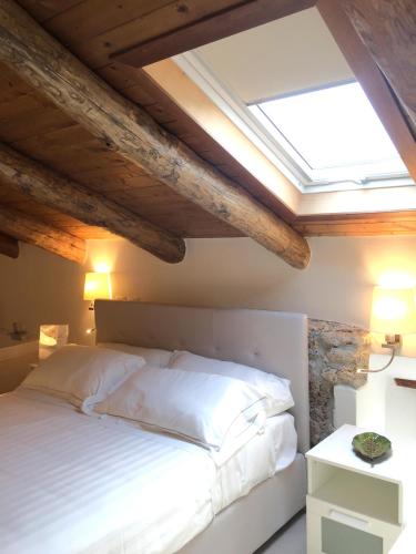 a bedroom with a white bed with a skylight at Casa Rubini in Paestum