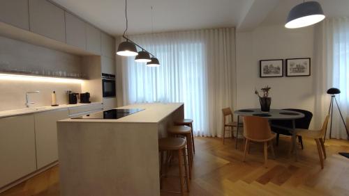 a kitchen with a counter and a table and chairs at Bratislava OLDTOWN Apartment 130m2 ,60m2 terrace and 2 bathrooms in Bratislava