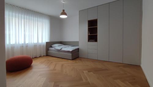 a white room with a bed and a closet at Bratislava OLDTOWN Apartment 130m2 ,60m2 terrace and 2 bathrooms in Bratislava