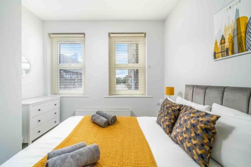 a bedroom with a bed with two pillows on it at Large Brick Lane Apartment - 1st Floor in London