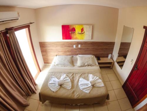 Una cama o camas en una habitación de Chamame - Pousada em Bonito