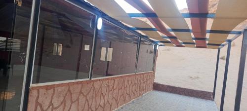 an empty building with glass windows and a ceiling at Wadi Rum Classic camp in Aqaba