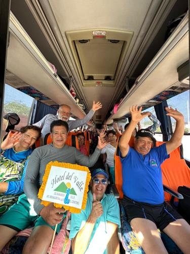 a group of people sitting on a bus at Hotel Del Valle in El Naranjo