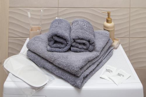 a couple of towels sitting on top of a toilet at Апартаменты Металлист посуточно ЛЮКС in Kharkiv