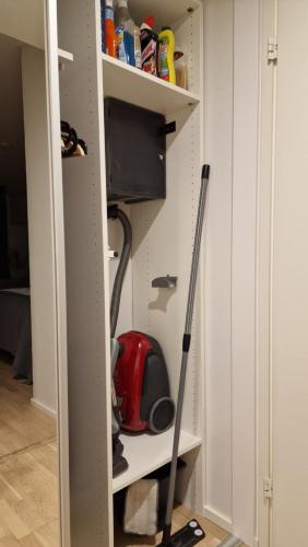 a room with a mop in a closet at Riverside apartment with french balcony in Turku