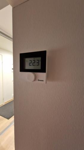 a clock on the side of a wall at Home away near services in Turku