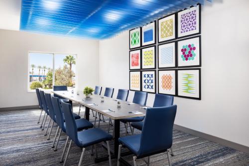 a conference room with a long table and blue chairs at Holiday Inn Express Las Vegas Stadium Area by IHG in Las Vegas